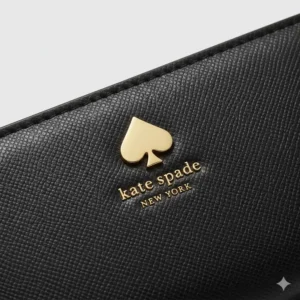 Close-up detail of the iconic embossed branding on the kate spade large continental wallet.