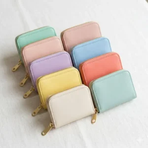 A variety of small zip coin purse options in pastel colors including mint green and blush pink.