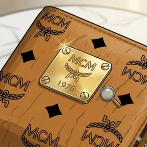 Detailed macro view of the engraved brass logo plate and hardware on an authentic mcm wallet.