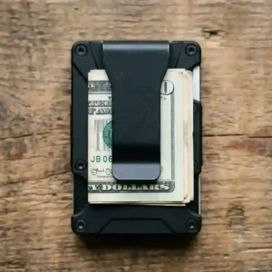 The backside view of a tactical slimline wallet featuring an integrated matte black money clip holding cash securely.